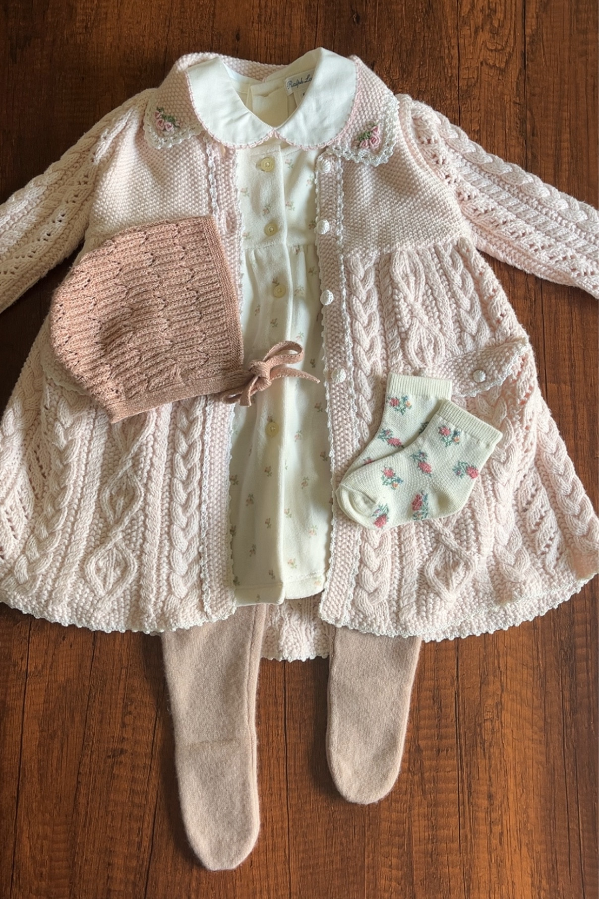 The most precious timeless and classic look for your little girl 🎀 This vintage look features a pink Ralph Lauren Aran Knit coat paired with a floral velour dress and embroidered Peter pan collar one piece. And to make it 1000% cozier, I added a tiny little knitted bonnet and floral socks 🫶🏽 Shop a similar look below! 

#LTKBaby #LTKKids