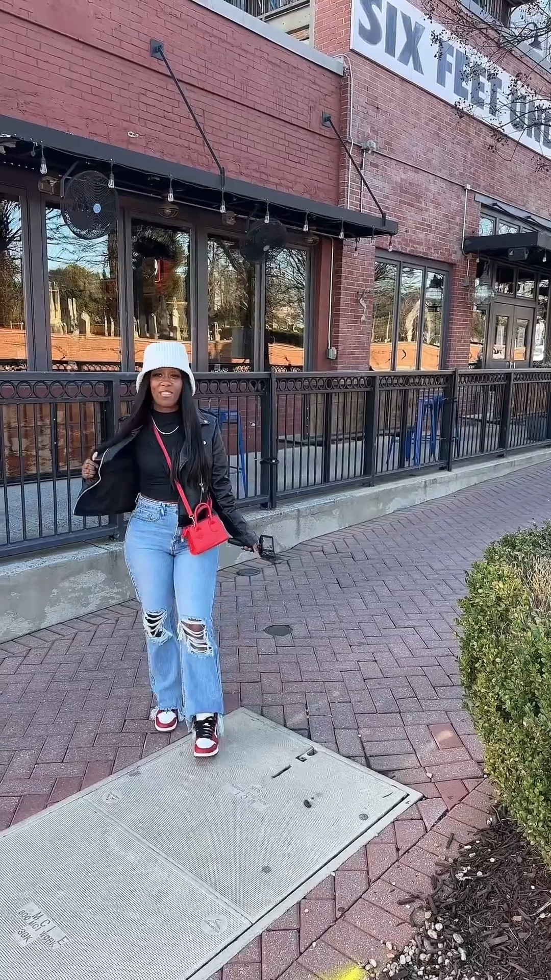 Outfit of the day. I’m wearing a black faux leather jacket, black long sleeve crop top, beige bucket hat, high waisted distressed jeans, red crossbody purse, and Jordan 1 sneakers

#LTKootd #LTKOver40 #LTKPetite