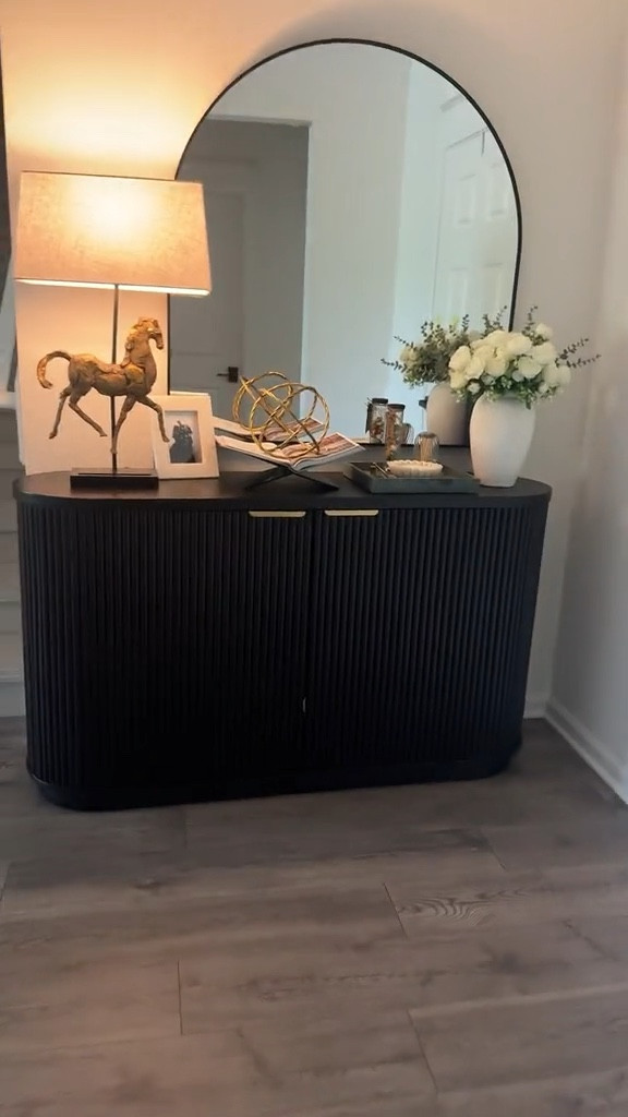 In French culture, the entryway isn’t just a pass-through space—it’s the first impression, a quiet introduction to the people who live there. I styled ours with that philosophy in mind: warm, intentional, and timeless with just a touch of old-world charm.

The arched mirror adds softness and balance
The antique-style horse and sculptural lamp bring a sense of collected history
Fresh florals for elegance and life
A softly-scented candle to make the space feel calm and inviting

Every detail is meant to feel thoughtful—like a gentle whisper of who we are before you even step inside. Linked the key pieces here in case you’re curating your own storybook entrance 

#ParisianDecor #EntrywayGoals #LTKHome #FrenchInspired #SoftAutumnStyle #CollectedHome #ChicAndTimeless #InteriorStyling #HomeWithHeart #CuratedHome

#LTKStyleTip #LTKHome #LTKFindsUnder100