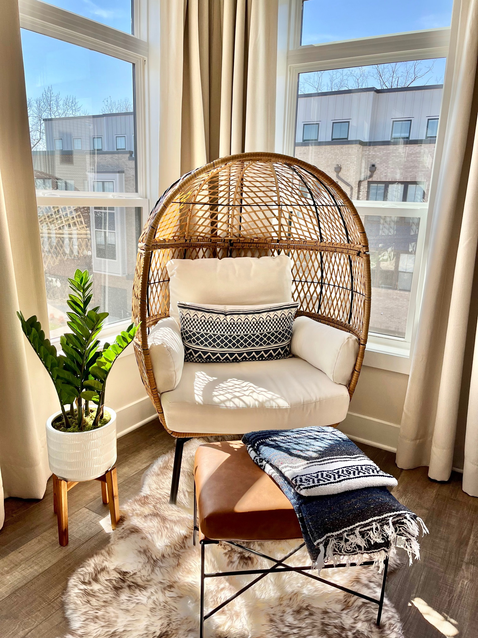 Love this bright and cozy corner of our home with our egg chair and an ottoman to lounge around 

#LTKhome