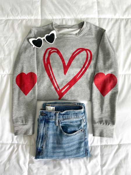Valentine’s Day 
Valentine’s Day outfit 
Casual Vday outfit 
Casual Valentine’s Day outfit 
Heart sweatshirt 
Graphic sweatshirt 
Jeans 
Heart sunglasses 

#LTKstyletip #LTKfindsunder100 #LTKSeasonal
