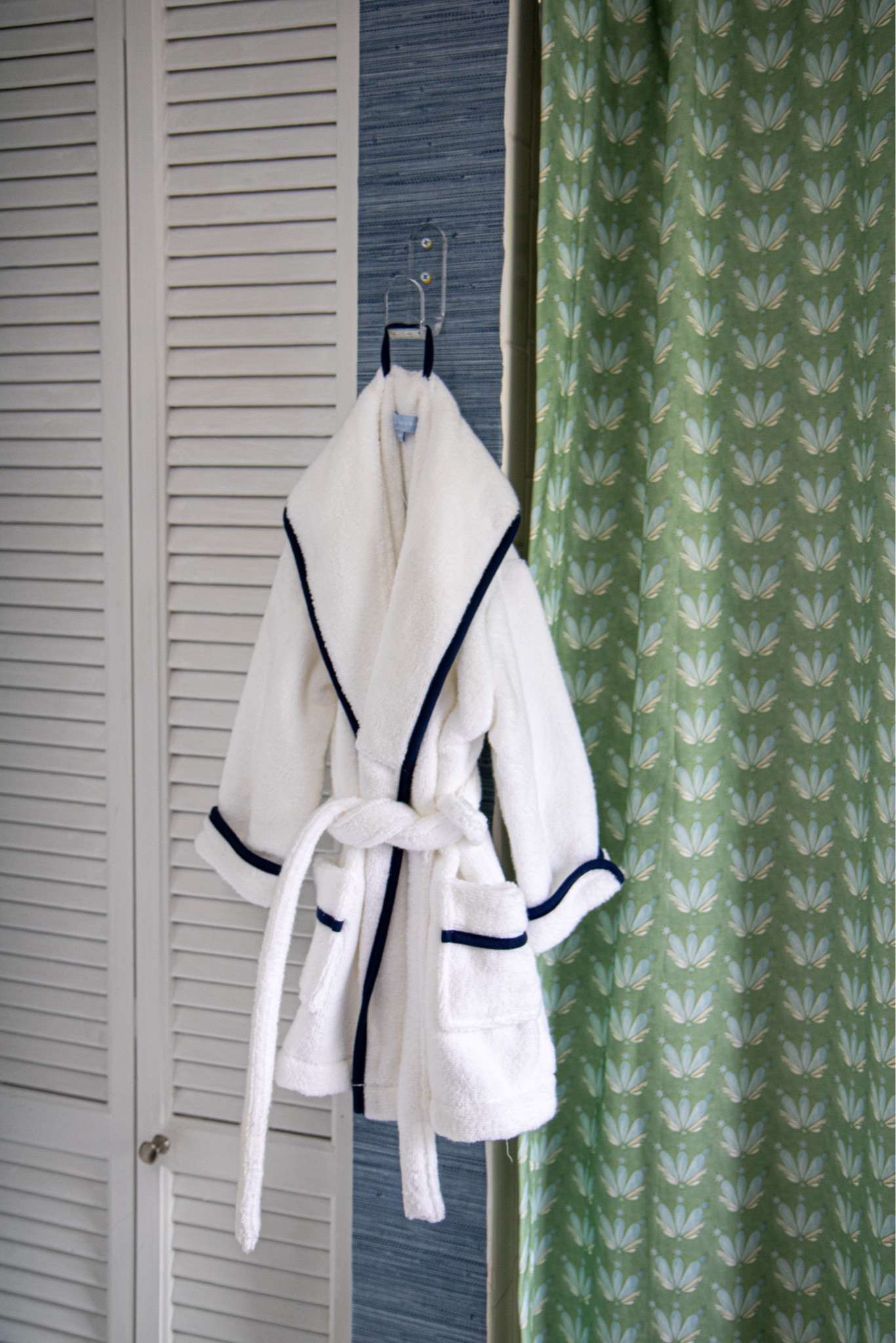 The boys bathroom update is finally complete. 💚💙 A weekend project that turned into MONTHS of hunting for the perfect shower curtain.. I did not think that would be the hardest part of this project! 🫠 Lucky for you I sourced this custom shower curtain from @pepperhome & it arrived DAYS after I ordered it! The rest of the project just took me a weekend - paint on the cabinet, peel & stick @socialsociety wallpaper, a new light & mirror! 

Boys bathroom, nautical bathroom, blue and white, green and blue home decor, grass cloth wallpaper, scalloped mirror, scalloped picture frame, #pepperhome #SLpartner #serenaandlily #socialsociety 

#LTKkids #LTKfamily #LTKhome