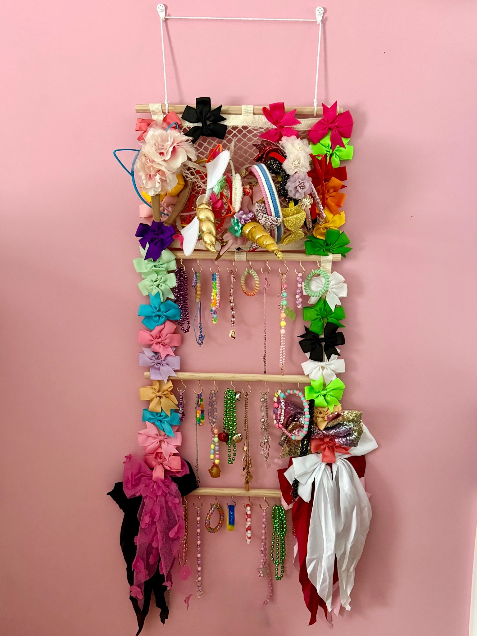 Finally a hair accessories and jewelry organizer I can get behind for T! Love the books at the base that also keep necklaces and bracelets organized! 