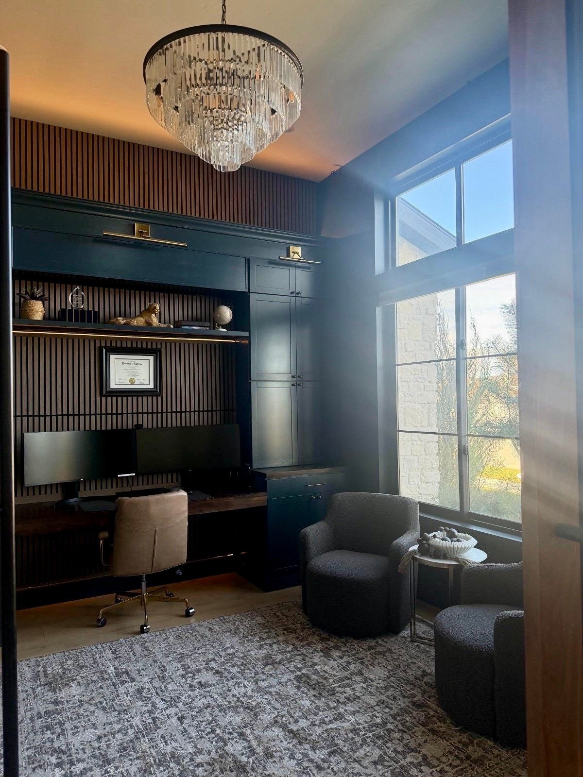 I pulled together this home office with a mix of warm wood, dark cabinetry, and soft layered textures to keep it feeling grounded and functional. The desk, task chair, and neutral rug create a comfortable workspace, while the accent chairs and small table add a relaxed seating area by the window.

I like choosing pieces that balance structure with comfort so the room works for both focused work and quiet breaks. Linking the key furniture, lighting, and decor I used here if you’re building a home office with a clean, tailored feel.
@Ashley homestore
 @Wayfair 
@Amazon
@Walmart