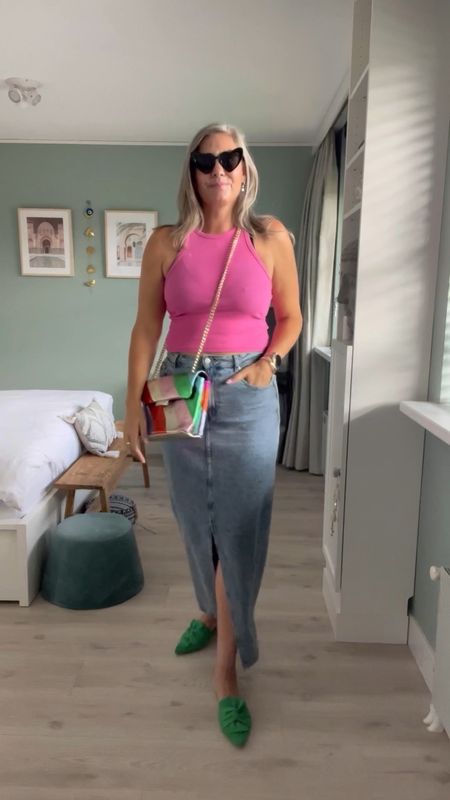 30 days of summer outfits. The best wireless bra and it converts into a racerback bra! Pink crop top, tall denim maxi skirt but I linked the regular length as well. Green Vivaia slip on sandals and a rainbow colored bag. Heart shaped sunglasses. 

#LTKeurope #LTKSeasonal #LTKstyletip