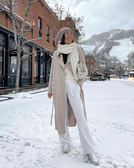 Kat Jamieson of With Love From Kat wears a winter outfit. Cashmere pants, neutral style, cashmere beanie, wool coat, clutch bag.

#LTKSeasonal #LTKstyletip
