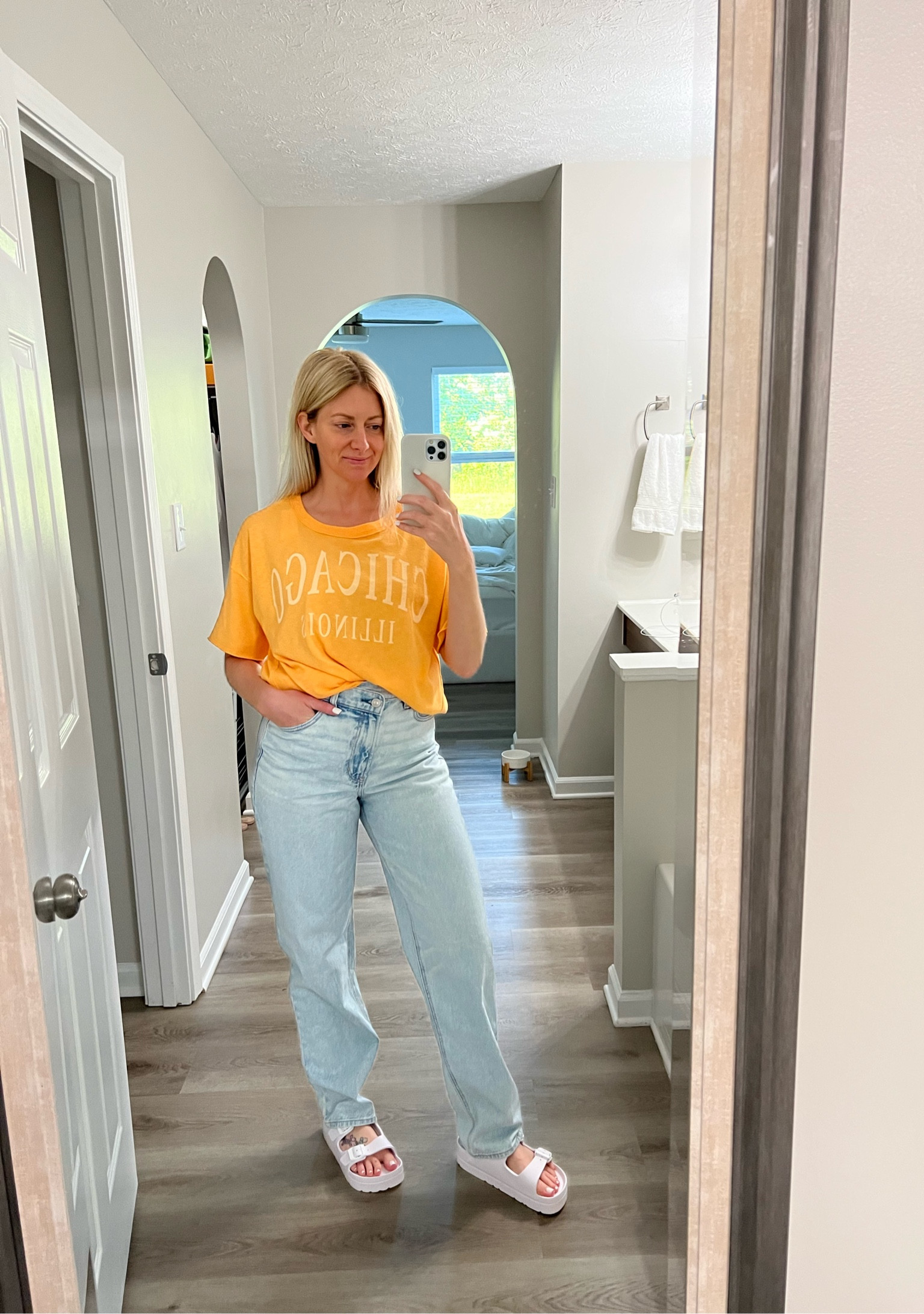 On sale! Oversized tee and baggy light washed jeans with crossover button. Wearing size xs/s in the tee and 4 in the jeans. 

#LTKstyletip #LTKunder50 #LTKsalealert