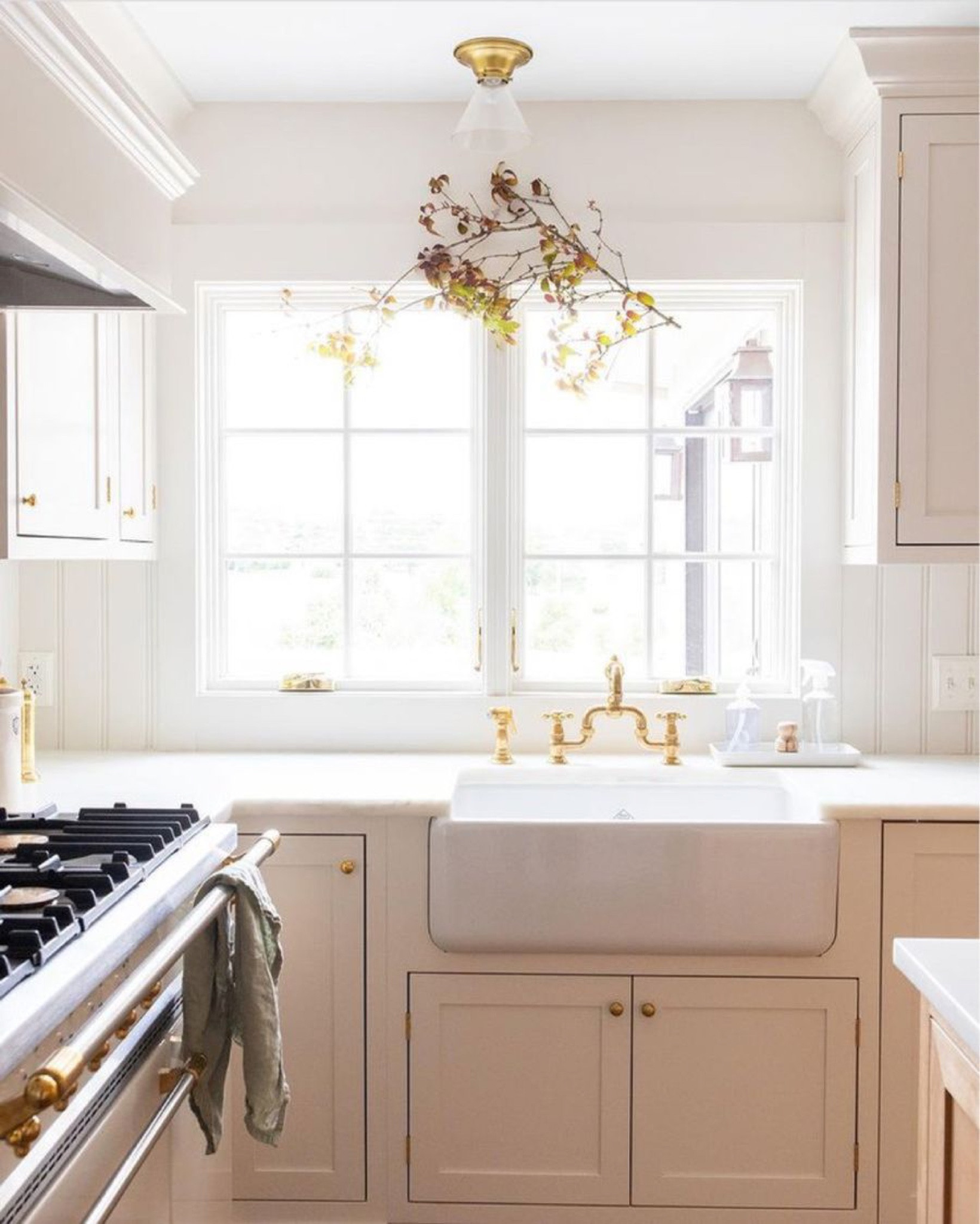 Warm and white kitchen with kitchen faucet, farmhouse sink, linen towels, kitchen kit, cabinet knob, and large jar. Kitchen inspiration, warm kitchen, kitchen decor, kitchen inspo, kitchen sink, kitchen towels, kitchen hardware.

#LTKSeasonal #LTKhome #LTKstyletip