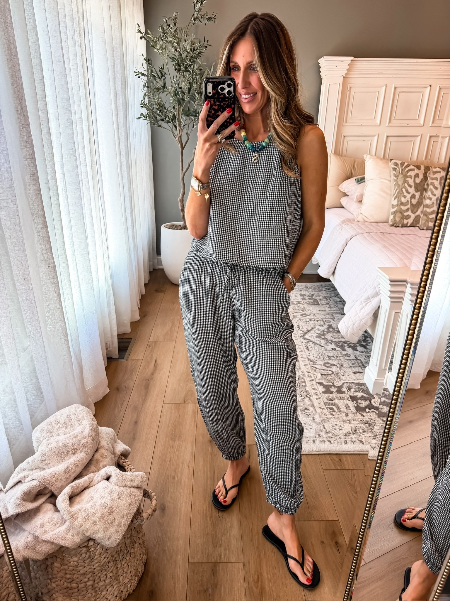 This gingham jumpsuit is lightweight, comfy, and so easy for summer days. I love that it feels casual but still looks styled with simple sandals and a fun statement necklace.

gingham jumpsuit, casual summer outfit, comfy everyday style, black and white outfit, effortless fashion, lightweight summer outfit, one piece outfit, casual chic look, vacation outfit ideas, affordable fashion finds, easy summer style, themominstyle

#LTKootd #LTKSeasonal #LTKmomlife