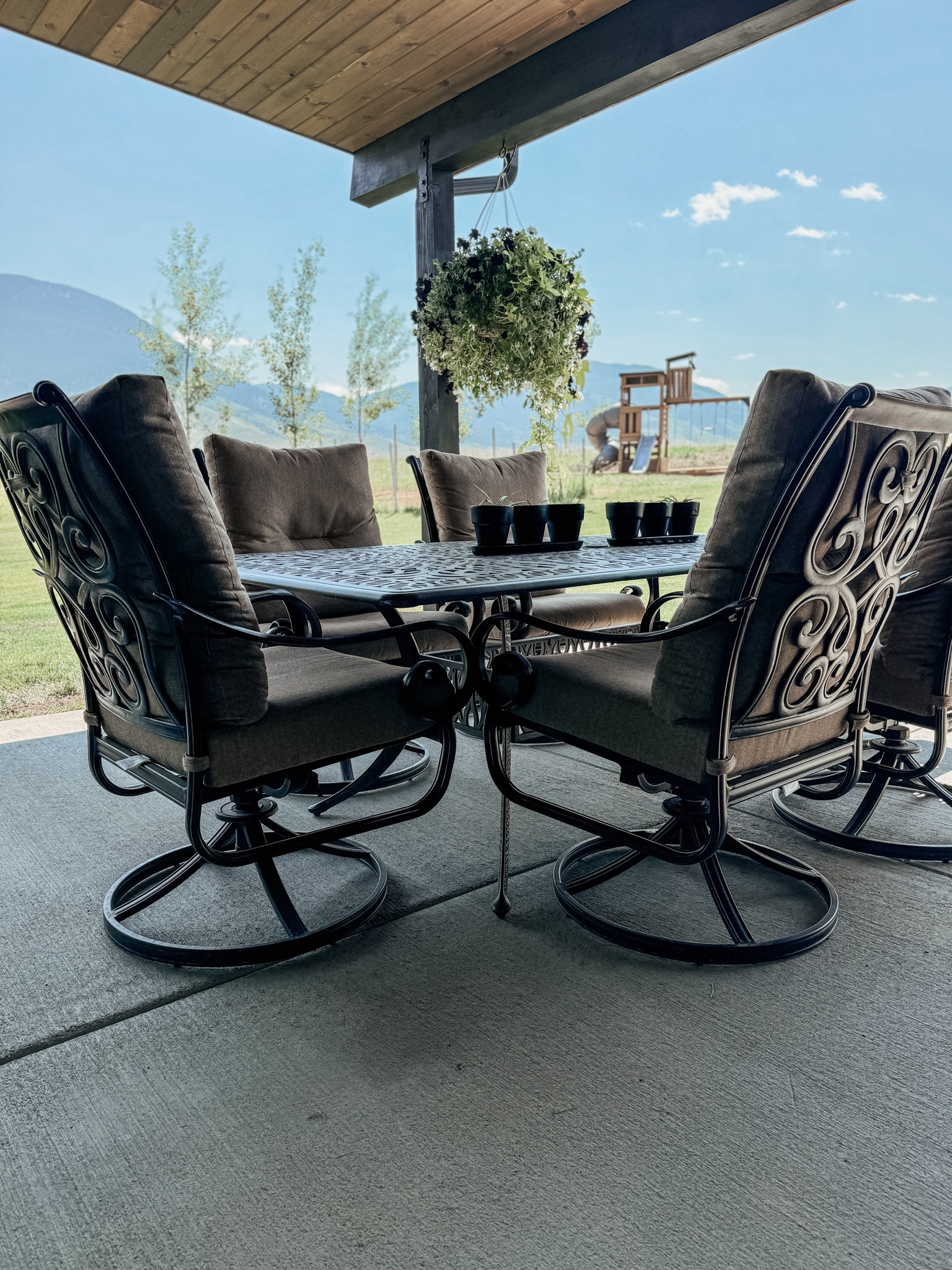 The absolute comfiest dining room patio set!! A heavy, large iron table with tall back patio chairs with the comfiest cushions! The chairs swivel and rock, and it makes the dining experience so cozy. We could sit in these chairs for hours, they are like recliners!!

#LTKHome
