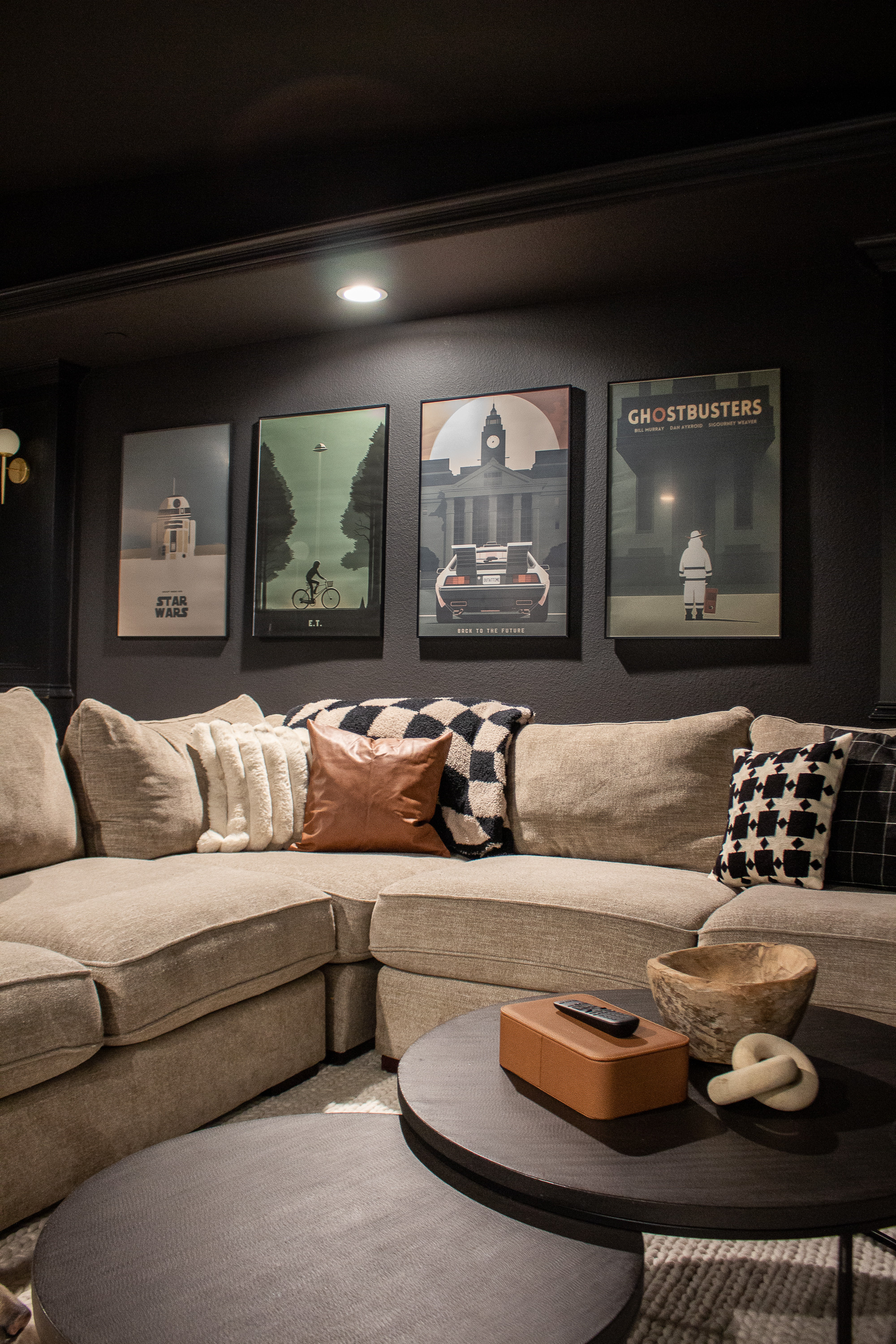 This moody media room is the perfect cozy hangout space. The dark walls, layered textures, and oversized sectional make it so inviting, while the framed movie posters add personality and a fun, nostalgic touch. I love how the warm throw pillows, modern coffee tables, and simple decor pieces pull the whole room together.
Sharing the sectional, pillows, wall art, lighting, and decor accents to help you recreate this modern home theater look.

#LTKSeasonal #LTKKids #LTKHome