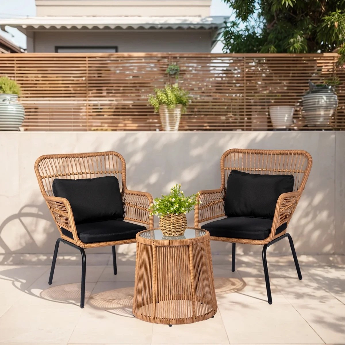 This 2-person patio conversation set from Wayfair is such a cute setup for a balcony or small backyard. I love the warm woven rattan-look chairs with black cushions, slim black metal legs, and the matching round side table in between. It’s included in Wayfair’s Labor Day Deal right now and feels perfect for coffee outside or an easy evening hangout. #WayfairFinds #PatioFurniture #OutdoorSeating #SmallPatio