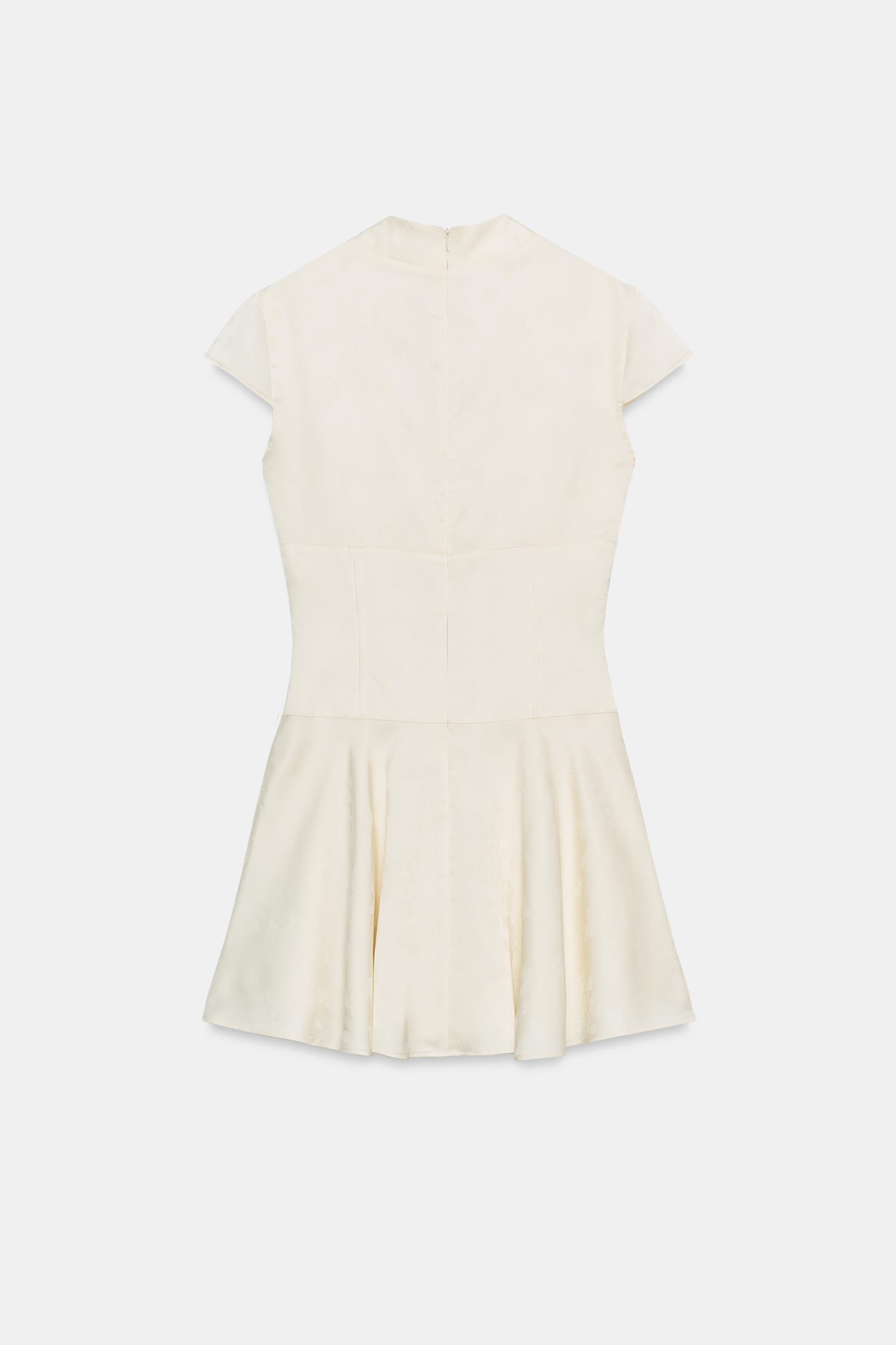 Deep V-neck dress with short sleeves. Front button detail. Tonal lining. Ruffled hem. Back hidden... | Zara US