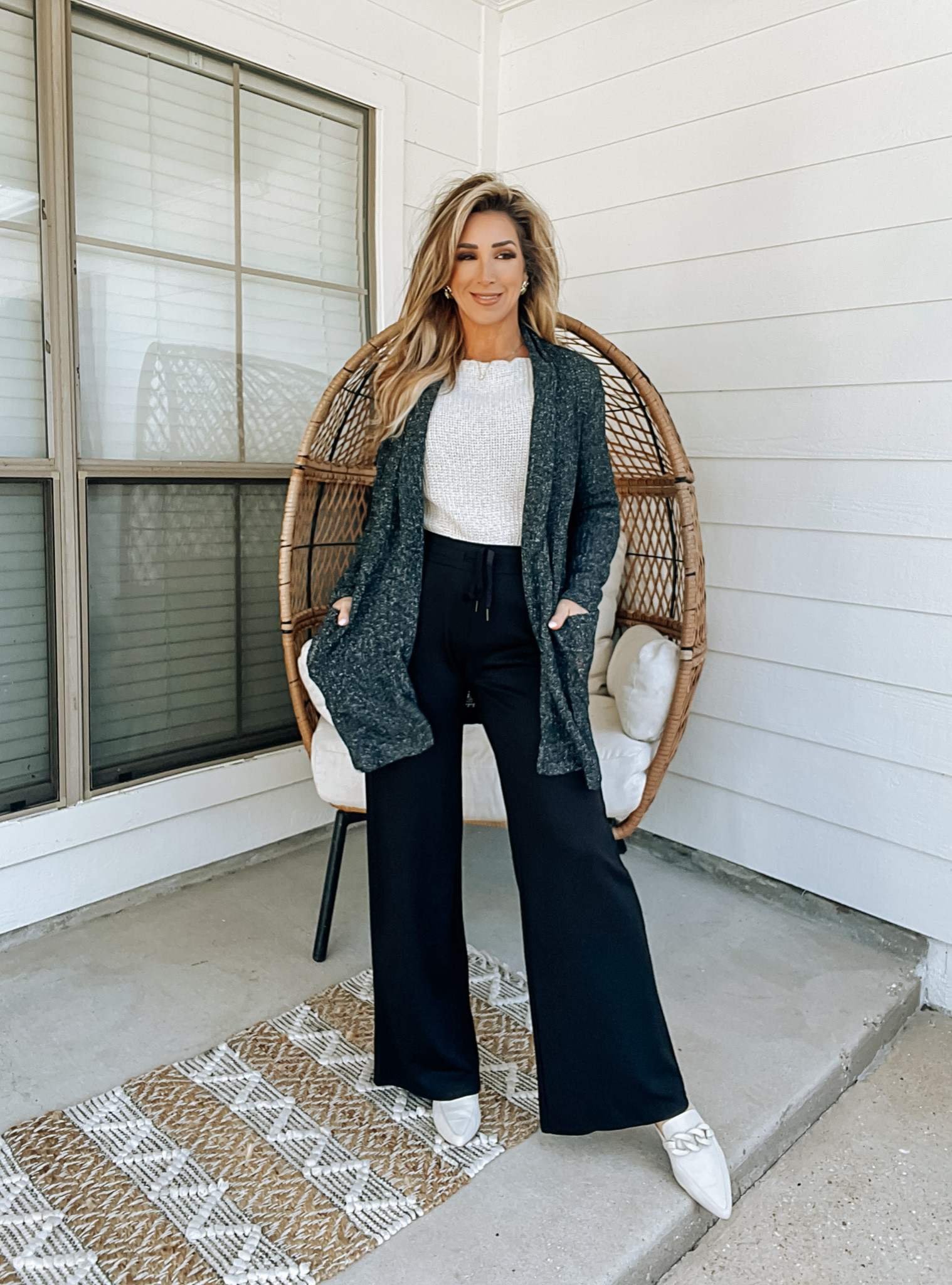 Dark grey knit cardigan with pockets, off white slouchy off the shoulder sweater knit top, black drawstring wide leg knit pants, business casual outfit, off whit mules slides

#LTKworkwear #LTKover40 #LTKstyletip