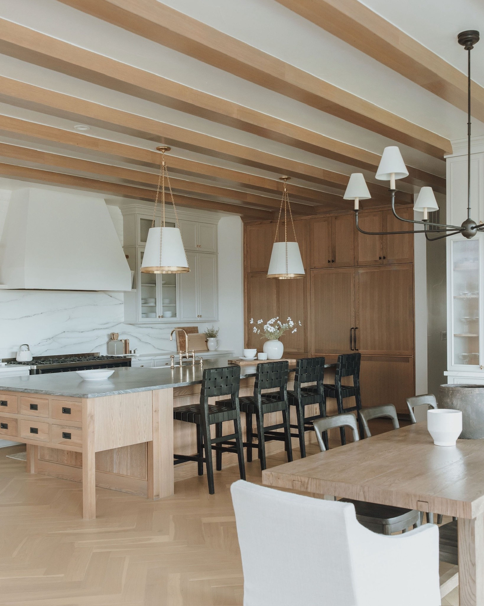 This kitchen design has us drooling. The woven black barstools add such a beautiful contrast. The pendant lights with the gold hardware really elevate the room. We love this light and bright kitchen. 

#LTKFamily #LTKStyleTip #LTKHome