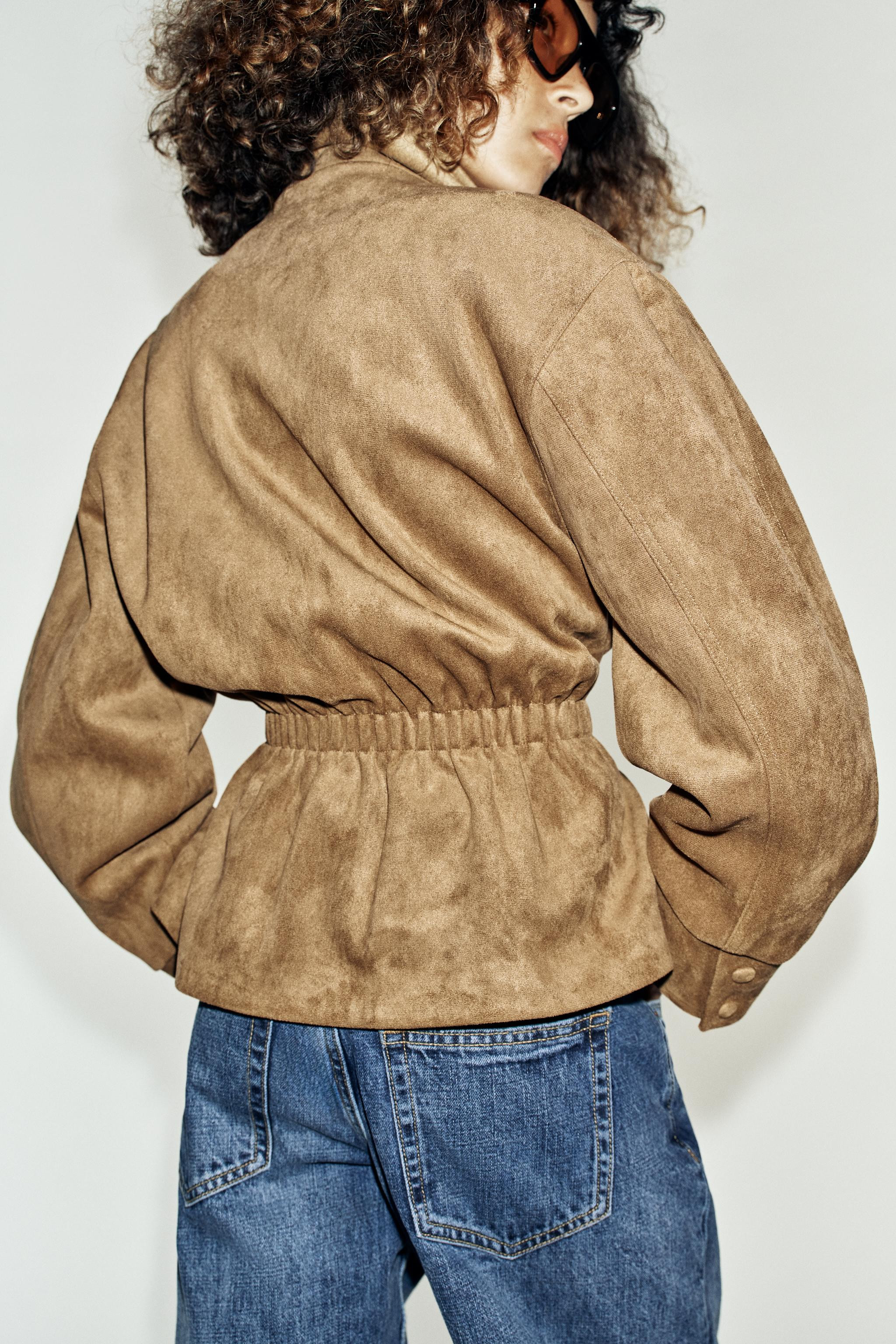 High-neck jacket with long sleeves. Front pockets. Features a matching fabric belt and gathered d... | Zara UK