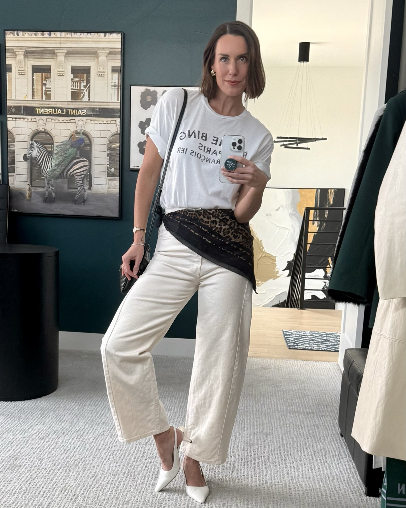 Spring is in the air! Love pairing a lightweight ecru denim with a soft white tee. This barrel leg jean style is so fun in this lightweight denim. Finished off the look with white leather sling back heels and black & leopard print accessories! Asymmetrical printed scarf around my waist pulls it all together, and such a fun ‘pop’!