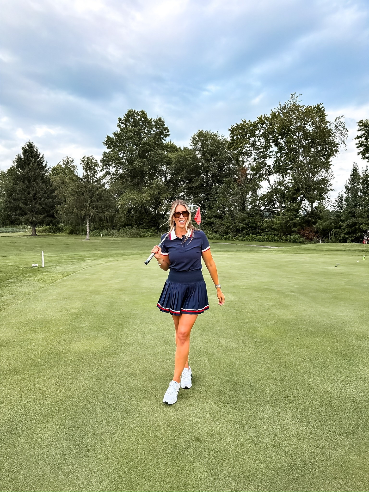 This golf outfit is equal parts sporty and classic. The navy polo and pleated skort feel timeless, while the striped trim adds just the right amount of color. It’s the kind of outfit that looks just as good on the course as it does grabbing lunch after your round.

golf outfit, golf fashion, pleated skort, navy polo, country club style, women’s golf apparel, athletic outfit, sporty chic, golf course style, activewear, TheMomInStyle

#LTKActive #LTKfitnessgoals #LTKootd