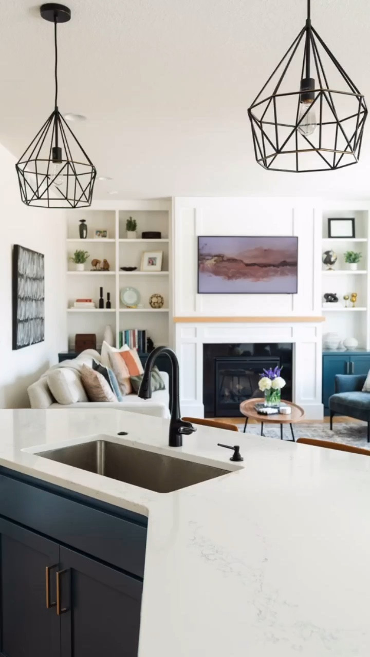 An open concept living room, grounded in neutrals with pops of color. Our #IGHnewbuild interior design project is a favorite for good reason. 🫶🏻 // Living room area rug, neutral sofa, oval wood coffee table, home accents, matte black kitchen faucet, faux leather counter stools.

#LTKFindsUnder50 #LTKHome #LTKFindsUnder100