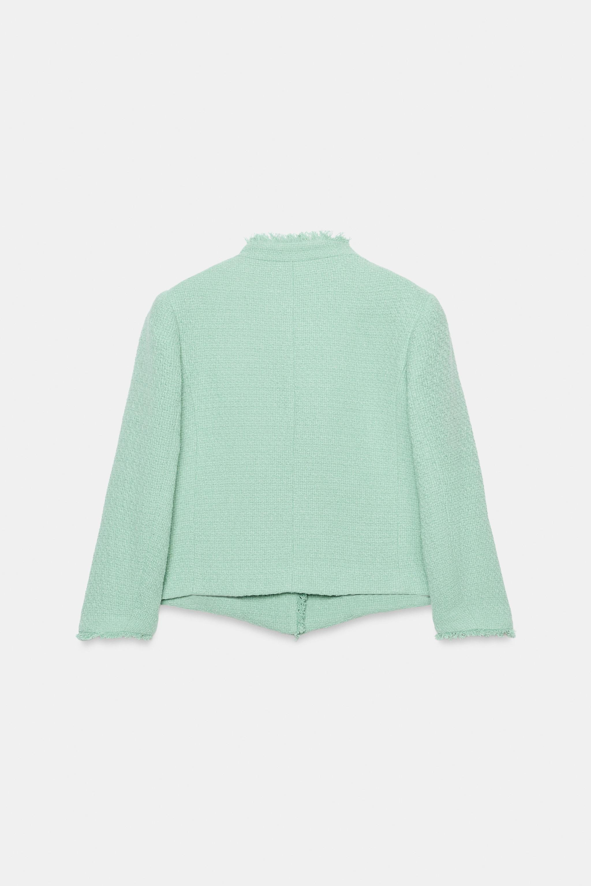 Stand collar blazer with long sleeves. Features front welt pockets, frayed trim finishes, and a d... | Zara US