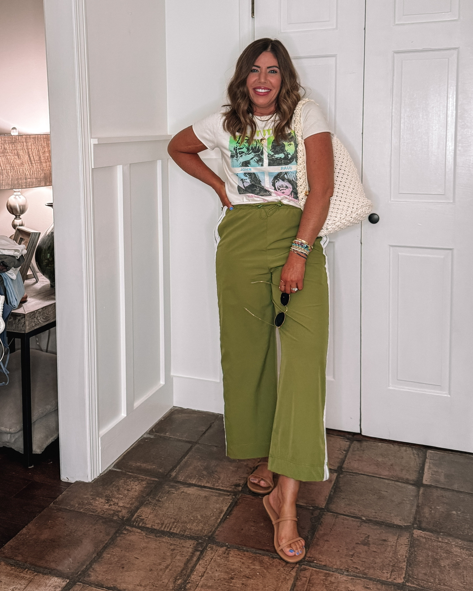 Under $40 VS. $110 for the Anthro track pant👏🏻

They come in three colors. They are high-rise, lightweight, and super stretchy. You can travel in them and so much more. They have a wide cropped leg with an adjustable waist. 
.
this graphic tee is old, but I linked several really cute ones here!

This white boxy crewneck is a look for less from Amazon. It is 95% cotton/5% spandex. It has raw seam details. The quality is so good. I sized up to a large, but I could have stuck with my true size medium. It's available in several colors!

😍I  started out with my true size medium, but felt like they were a little too snug in the hips, so I sized up to a large, but now I kind of like both fits which one do you like best? 

Over 40 style, travel outfit, summer outfit

#LTKMidsize #LTKgrwm #LTKOver40