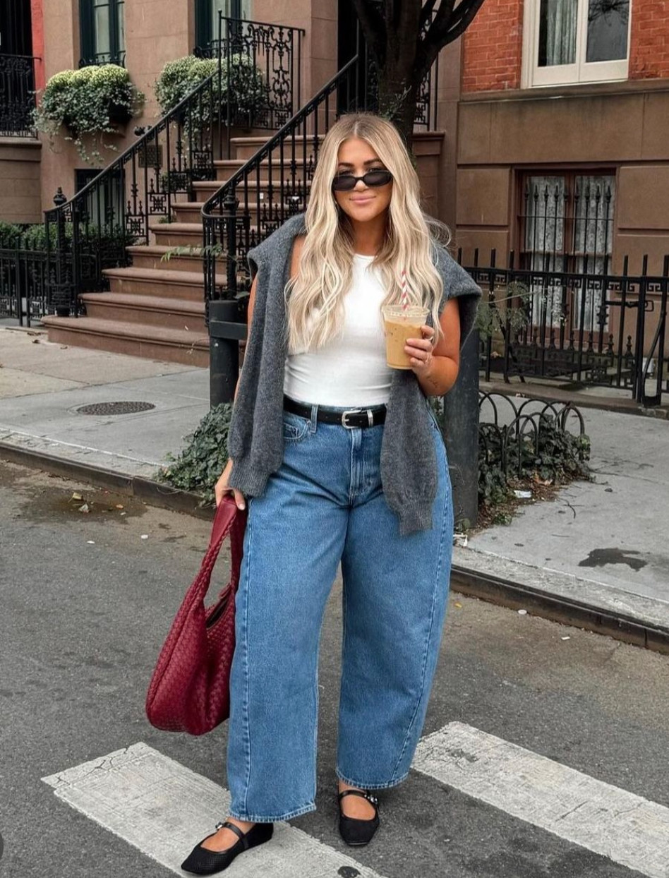 This easy everyday outfit pairs relaxed wide-leg jeans with a fitted white tank and a cozy sweater draped over the shoulders for an effortlessly chic look.
Classic accessories, ballet flats, and a statement bag elevate the casual denim into a polished street-style outfit. 

 #LTKdayinmylife #LTKootd