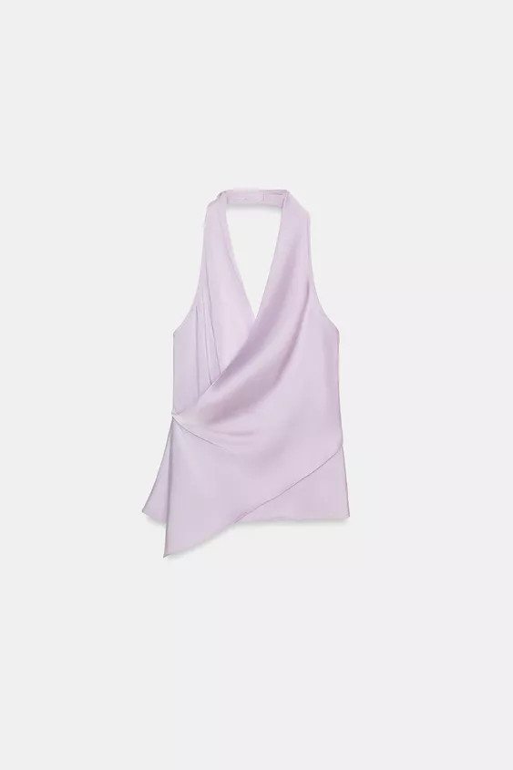 Top made of satin fabric. Halter neck and crossover v-neck. Open back. Asymmetric hem. Side butto... | Zara UK