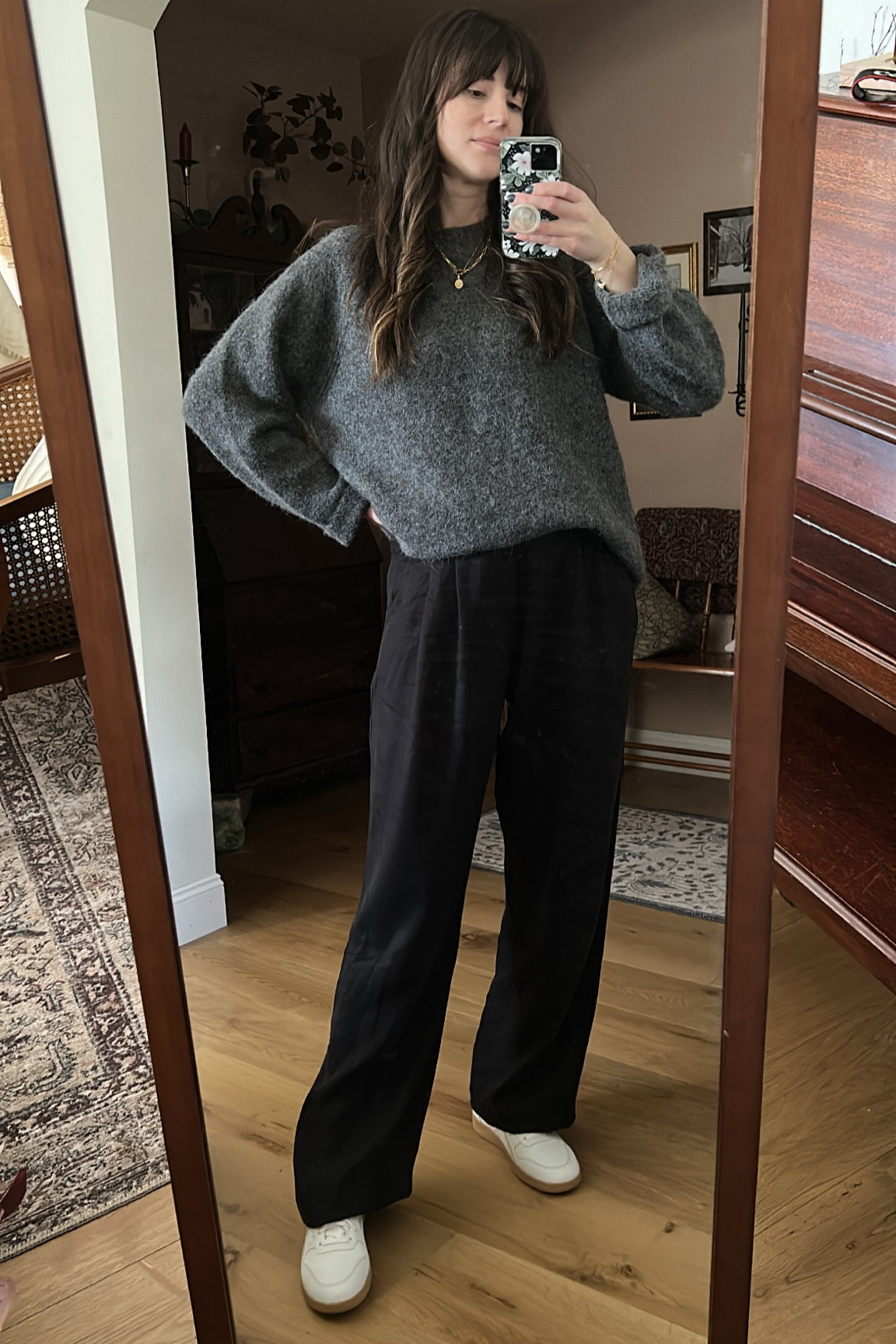 Winter outfit: oversized grey sweater, black wide leg trousers, white sneakers, and layered gold jewelry. 
Pants are Saunter Trousers from Darling Society. ‘JESSICAW’ for 15% off