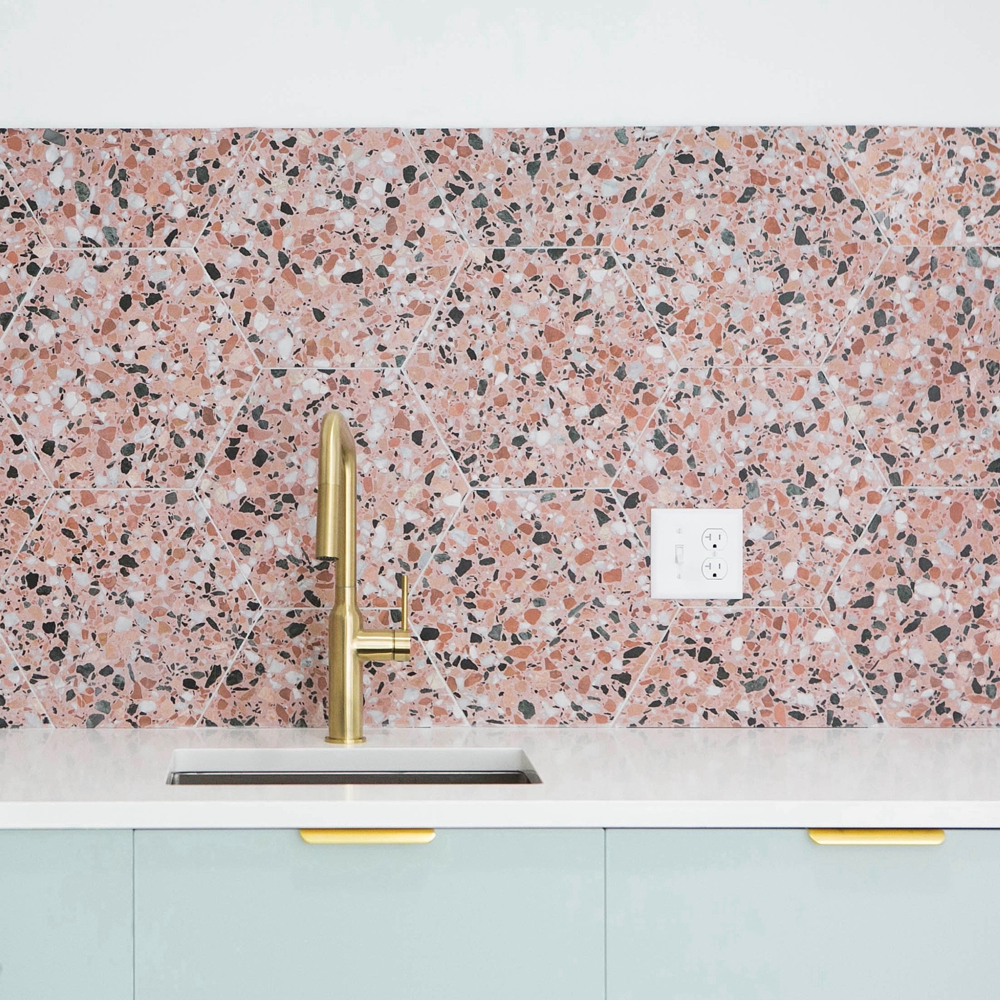 from dark and dingy to light and bright! when renovating the #goldengirlscondo, we opened up the kitchen and streamlined the layout. we had fun with color and pattern, pairing @semihandmade Supermatte Agave Slab cabinets with this fun terrazzo-inspired backsplash tile from @tilebar. gold finger pulls and a gold faucet add the finishing touch. #dwelloctober

#LTKhome