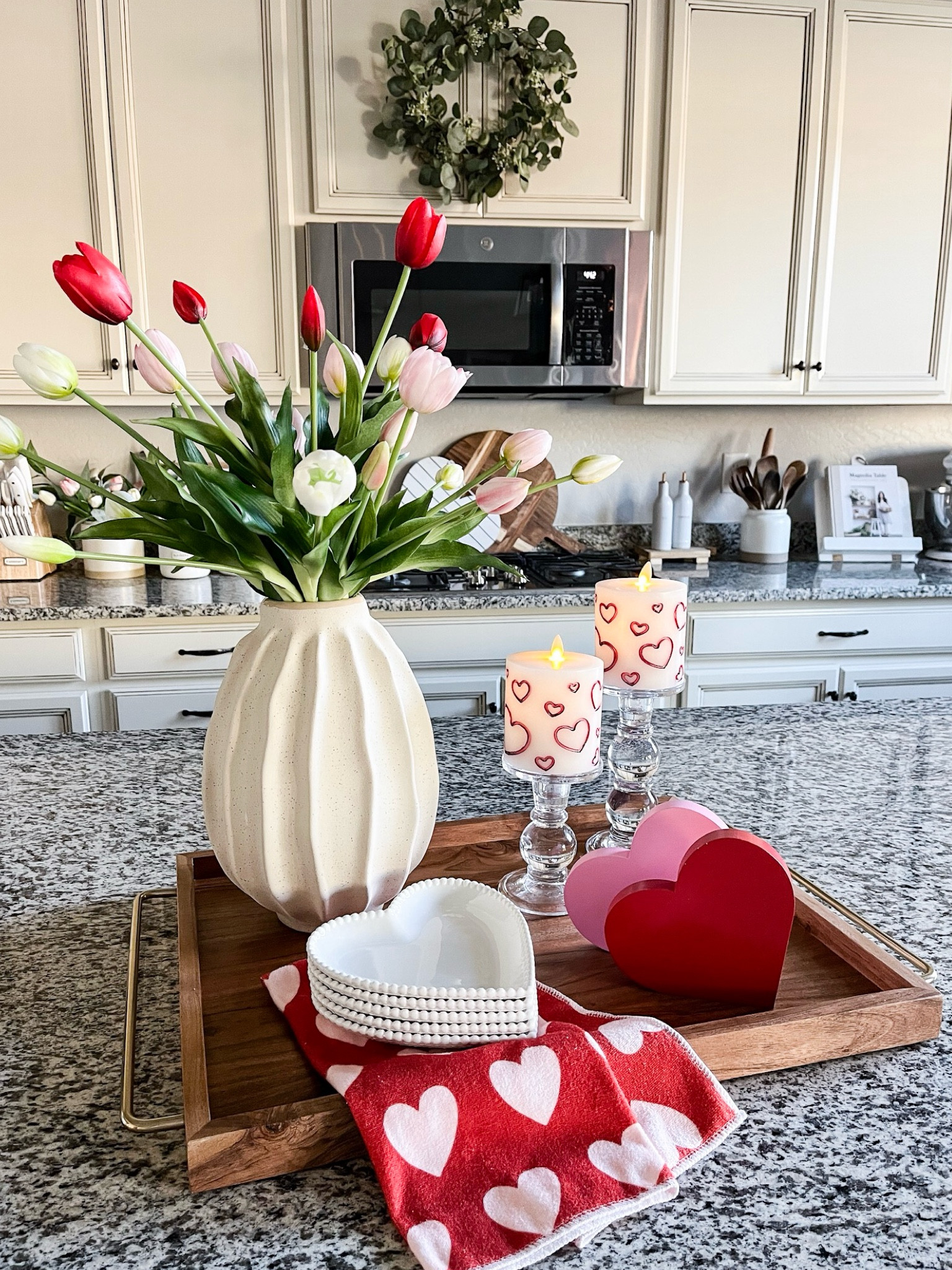 VALENTINE'S DAY tray styling! Follow @lifeinmyarizonahome
on Instagram for more inspiration.

These beautiful tulips are so realistic looking. Each color comes in a set of two bunches. I separated the bunches for easier styling. I love the gorgeous detail on the heart plates. They come in a set of 10 so I will use the other half of them in my coffee bar.

Wood handled tray | wavy vase | real touch tulips | glass candle holder | luminara flameless heart candle | wood heart decor | heart towel | white heart plates

#valentinesdecor #traystyling

#LTKGiftGuide #LTKHome #LTKSeasonal