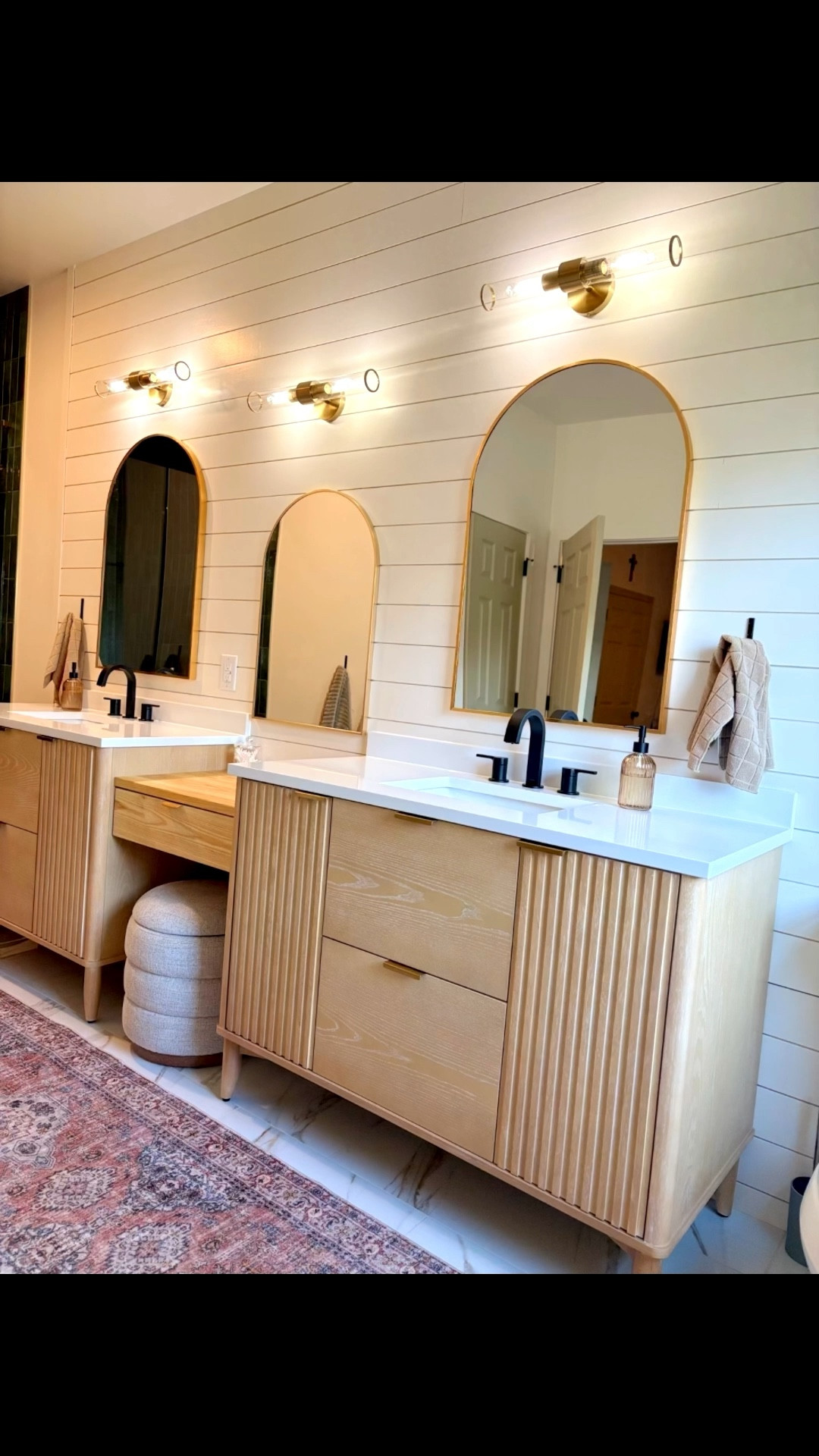 Our master bathroom has two tall modern organic vanities, light sconces and a custom makeup vanity. We mixed black and gold finishes to create this beautiful look! 

#LTKHome #LTKFamily