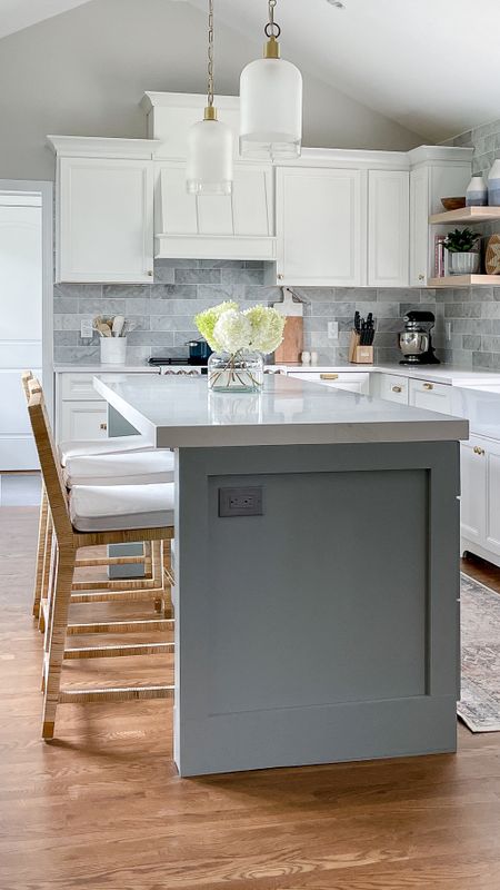 Bright and clean, coastal themed kitchen with white cabinets, Serena & Lily rattan barstools, white cabinets, and brass and gold fixtures 

#LTKhome #LTKfamily
