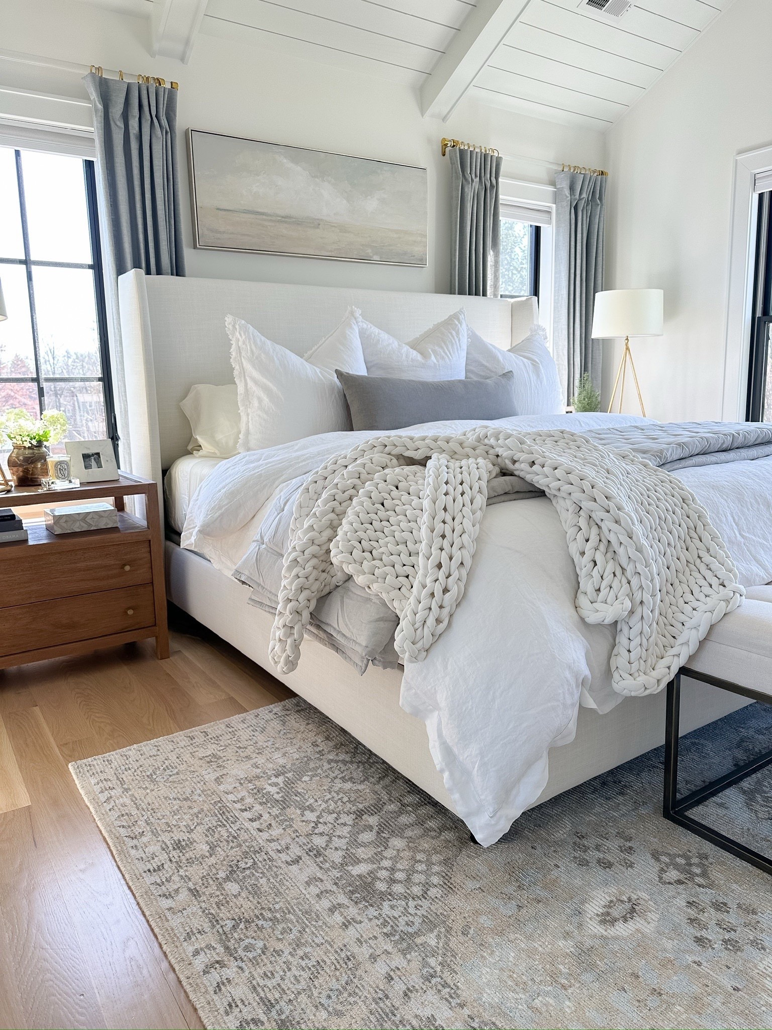 Primary bedroom decor, neutral coastal decor, bedroom furniture

Paint color: Benjamin Moore Simply White
Rug: 8x10 - it’s very soft and I love the muted vintage vibe! Is frequently out of stock
Bed: King size in Zuma White. We have a standard size boxspring and 12” thick mattress
Curtains/Drapes: 84” length, 50” wide in mineral blue with light filtering lining
Curtain Rods: Acrylic & Brass with 1.25” diameter rings
Art: I found it locally (preframed) but I’m linking the same art on stretched canvas in a similar size.
Pillows: 4 king size bed pillows, 3 26” Euro pillows (from Amazon), 2 20” blue linen throw pillows, 1 14x36” light gray lumbar pillow
Bedding: Organic cotton duvet cover in white with medium weight down insert (king), Waffle bed blanket in natural (king)
Chunky Throw: This is actually a 15lb weighted blanket in cloud white

#LTKFindsUnder50 #LTKHome #LTKFindsUnder100