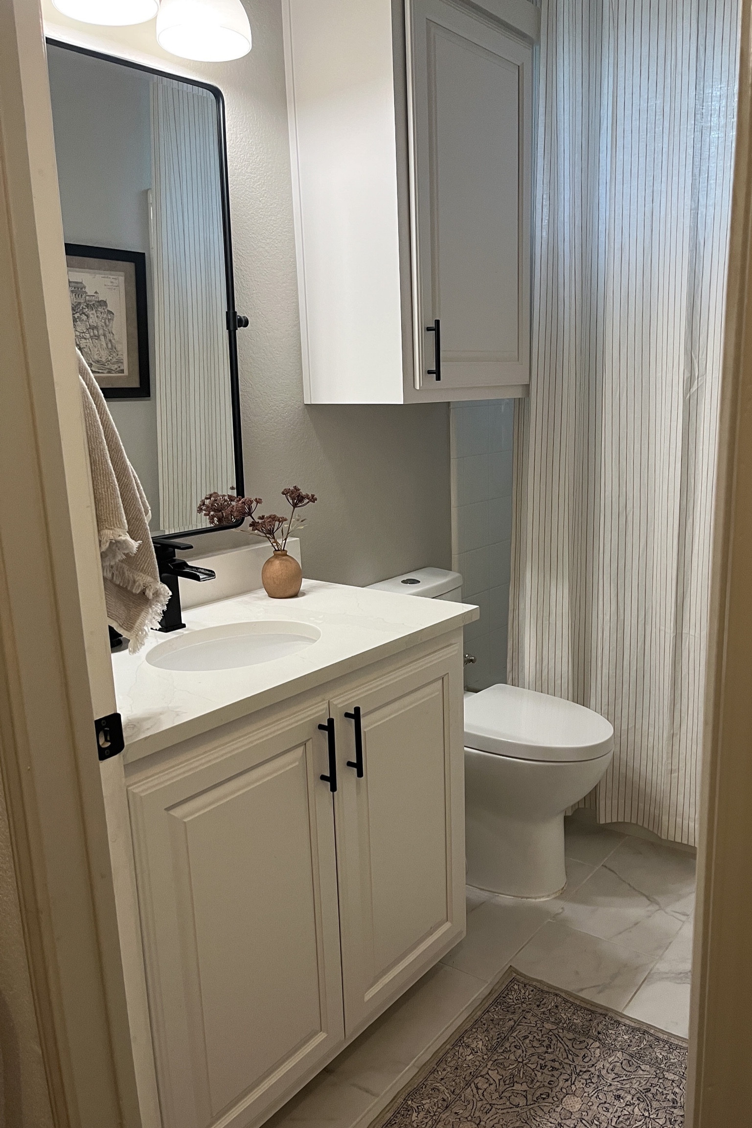 Bathroom with long shower curtain and washable rug 

#LTKhome #LTKstyletip #LTKSeasonal