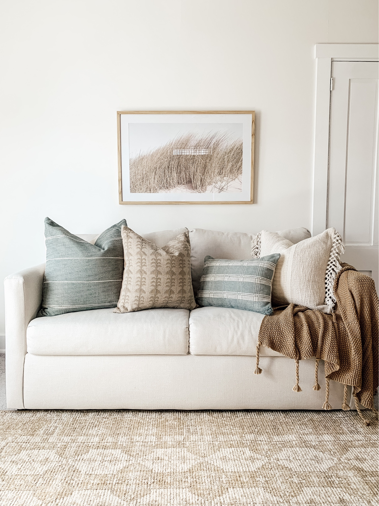 Spring and Summer decor from Threshold Studio McGee line @Target. Neutral coastal living room decor. Beach art, vintage area rug, neutral textured throw pillows. @TargetStyle #Target #TargetPartner #TargetStyle

#LTKSeasonal #LTKhome