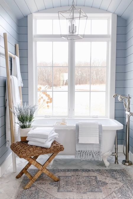 Master bathroom - freestanding white tub - white clawfoot tub - Serena and lily - master bath lighting - coastal farmhouse dusty blue - bath towels 

#LTKhome #LTKstyletip