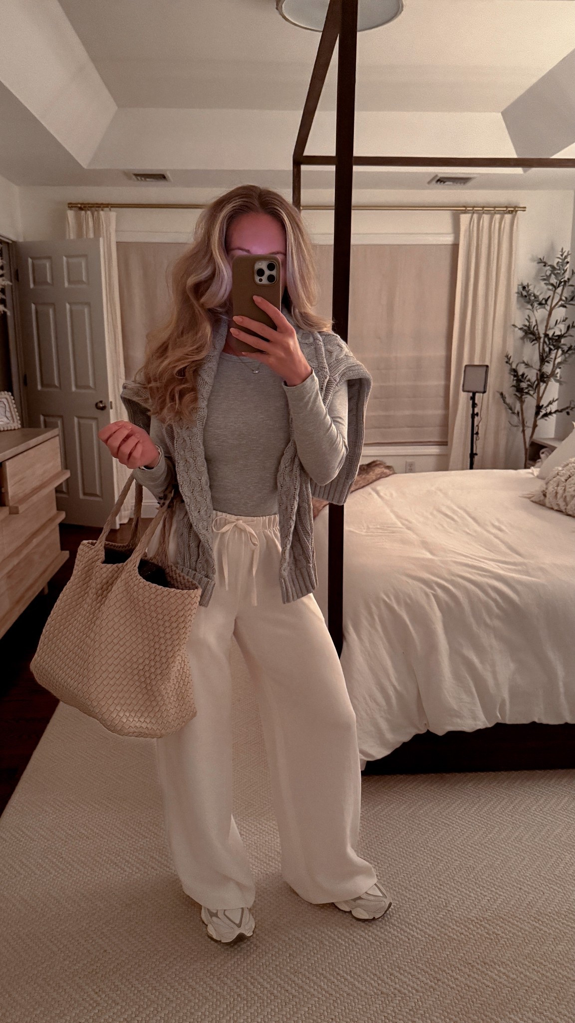 Travel outfit wearing aritzia lodge pants with new balance sneaks & naghedi tote bag  