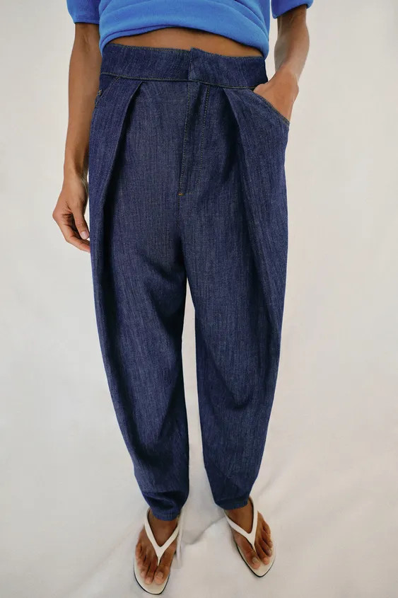 Pants made with linen. High-waisted with front pleats and five pockets. Relaxed leg tapering towa... | Zara US
