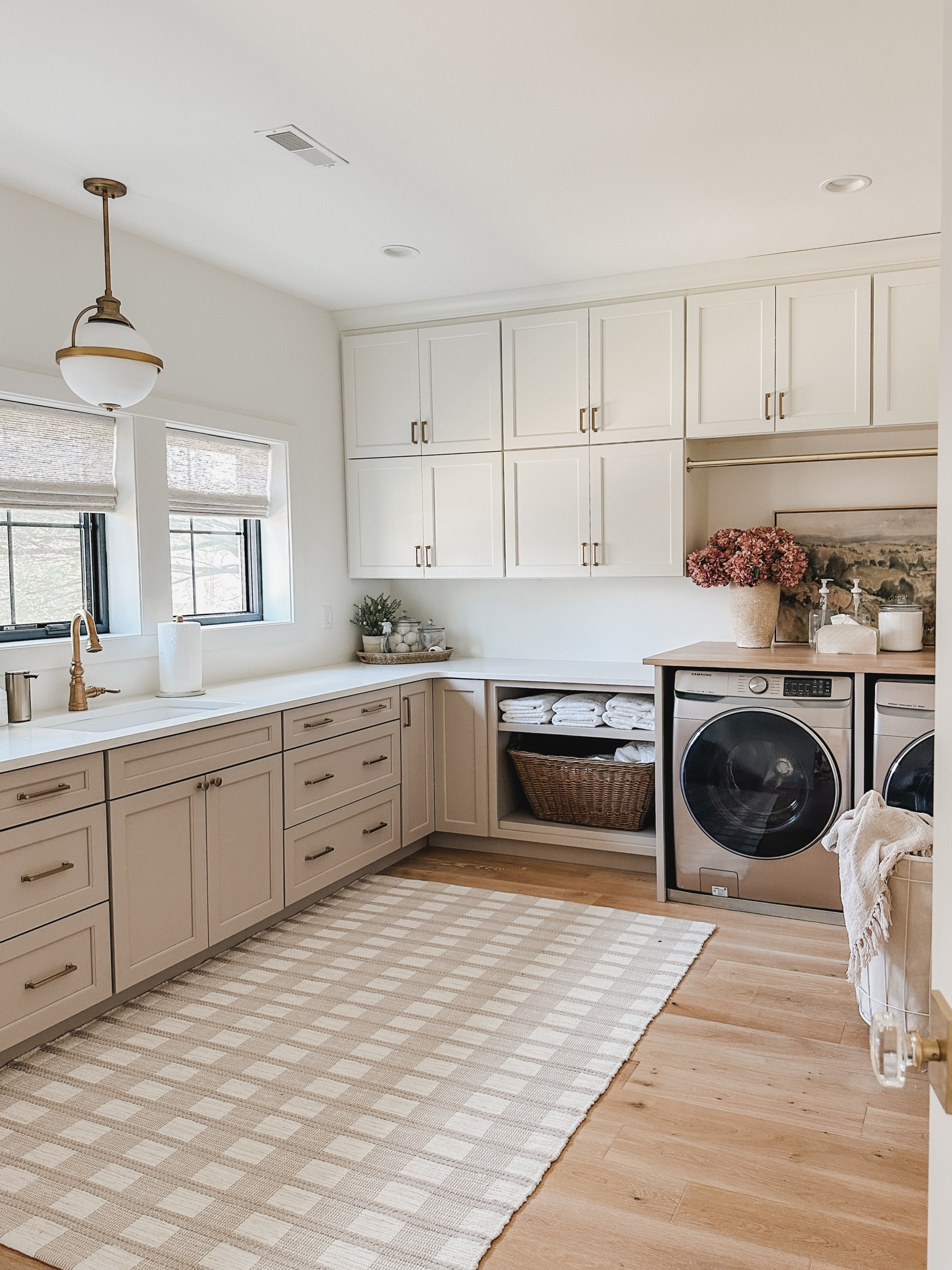 Bright and airy laundry space with faux florals and neutral area rug. With our laundry room being highly utilized it was important to keep this space aesthetic yet functional 

Spring home, light and bright, laundry room, neutral area rug, organization details, aesthetic home, lighting details, gold detail, laundry basket, laundry organization, faux florals, found it on Amazon, Target, basket faves, towel finds, spring refresh, shop the look!

#LTKhome #LTKstyletip #LTKSeasonal