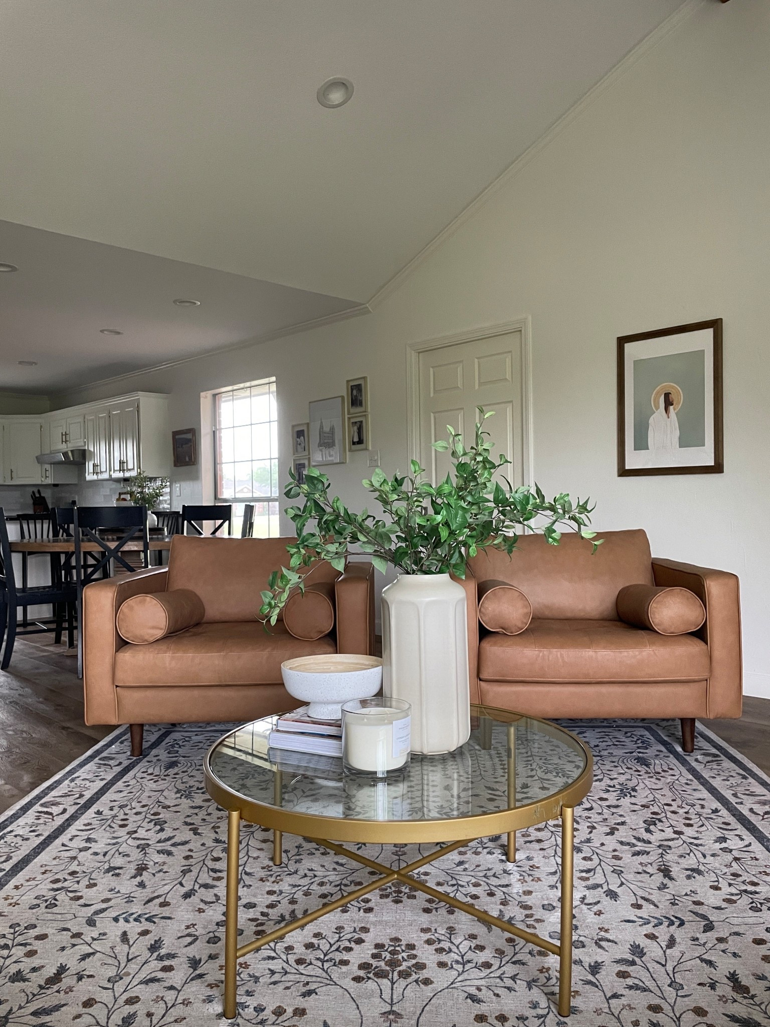 Conversation area in the living room is easy with these living room armchairs. These genuine leather chairs are comfy, beautiful and durable. The rug has a unique pattern and lovely colors. The vase is really big and looks great with stems in them. 

#LTKHome