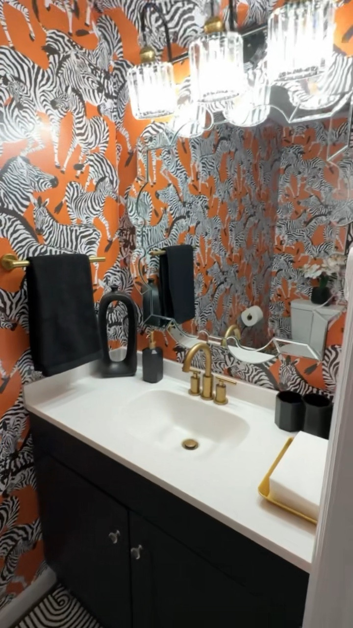 Unique and colorful eclectic powder room design with zebra print wallpaper and black and gold accents. Maximalist style home decor. #bathroomdecor #eclecticdoor #colorfulhome #powderroom

#LTKFind #LTKhome #LTKsalealert