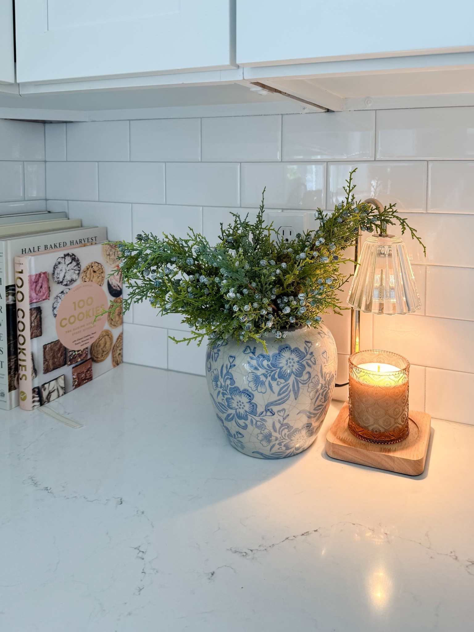 Cozy kitchen counter moment. This kitchen counter setup proves that simple details like cookbooks, greenery, and warm lighting can make everyday spaces feel welcoming.

Coastal kitchen decor, neutral kitchen, blue and white accents, cozy home details, simple styling, cape cod kitchen, everyday home inspiration, timeless design, Sherri calnan home

#LTKHome