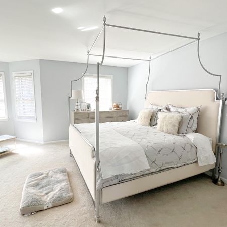 Soft & serene master bedroom with silver canopy bed, trellis duvet cover, coordinating dog bed, and large modern dresser styled with picture frames, and a wedding bouquet display box  

#LTKhome