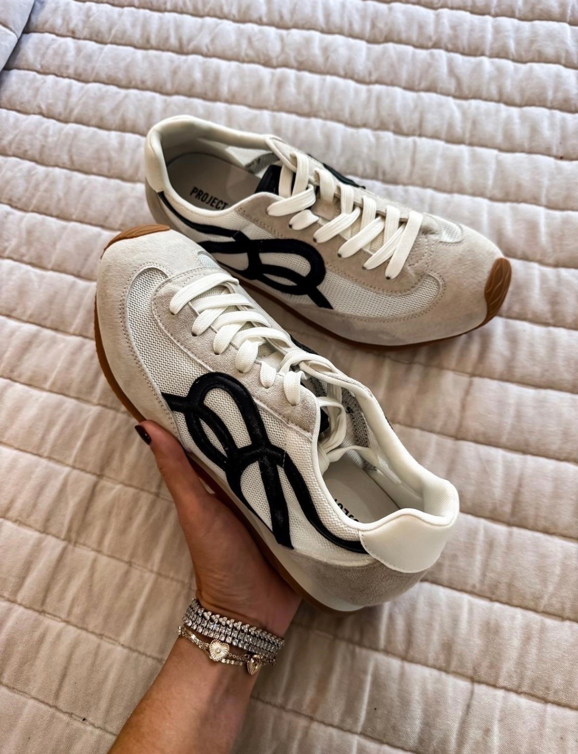 These sneakers are such a good designer-inspired find! 🤎 Love the cream and black combo with the gum sole for an easy everyday shoe that works with jeans, leggings, and casual fall outfits.

cream sneakers, black and white sneakers, designer inspired sneakers, casual shoes, gum sole sneakers, everyday sneakers, fall shoes, sneakers with jeans, casual fall outfits, women over 40 fashion, themominstyle
