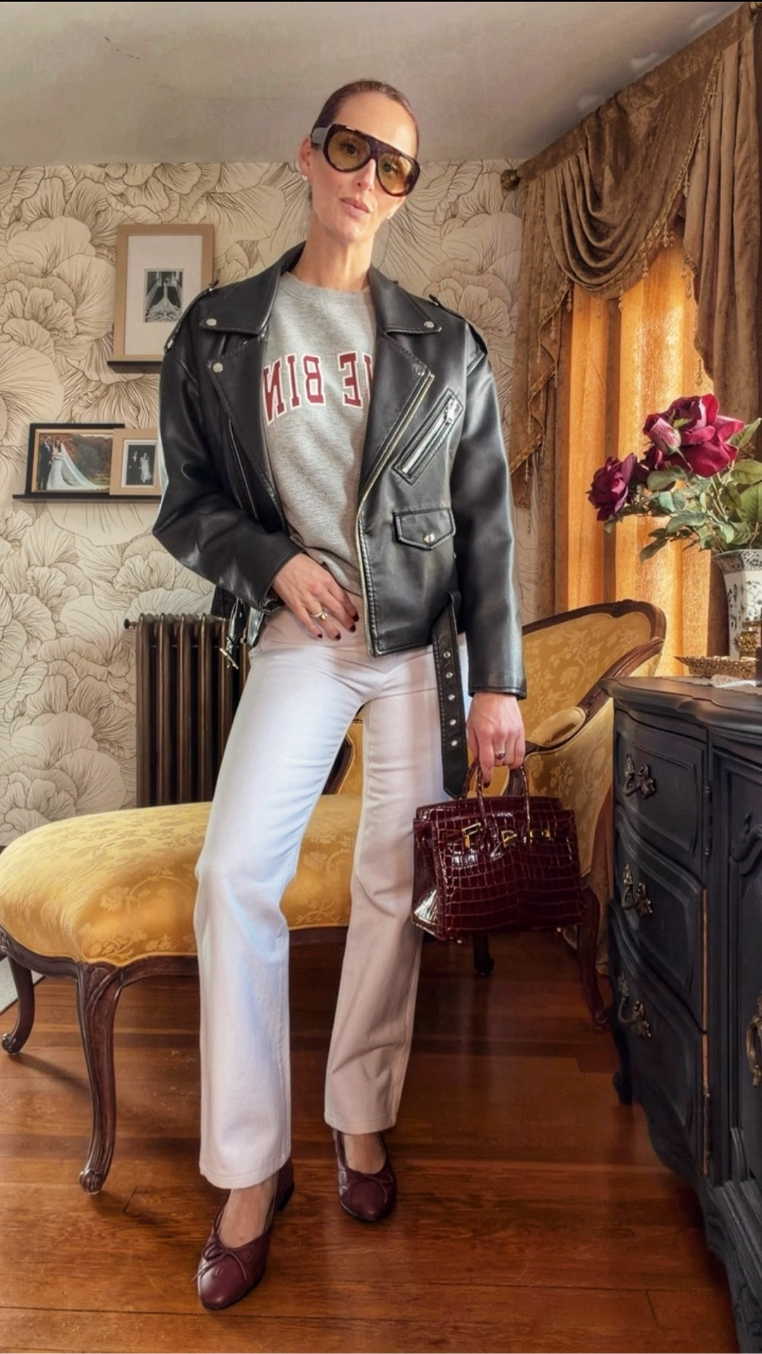 An easy spring outfit formula I’ll be repeating on rotation 🤍 A graphic sweatshirt layered under a structured leather moto jacket instantly adds edge, while these soft neutral straight-leg pants keep the look polished and wearable. Finished with burgundy accessories for a rich, elevated touch—this is how you make casual feel intentional.

Perfect for everyday styling, errands, coffee dates, or a casual client day when you still want to look put together.

Styling notes:
– Moto jacket = instant structure + polish
– Neutral trousers elongate and balance the look
– Burgundy accessories add depth (the chicest alternative to black)
– Oversized sunglasses = effortless finish

Spring outfits 2026

#LTKStyle #LTKSpring #EverydayStyle #CasualChic #NeutralOutfit #LeatherJacketOutfit #EffortlessStyle #MinimalStyle #SpringOutfits #ElevatedBasics #OOTDStyle

#LTKgrwm #LTKootd #LTKSeasonal