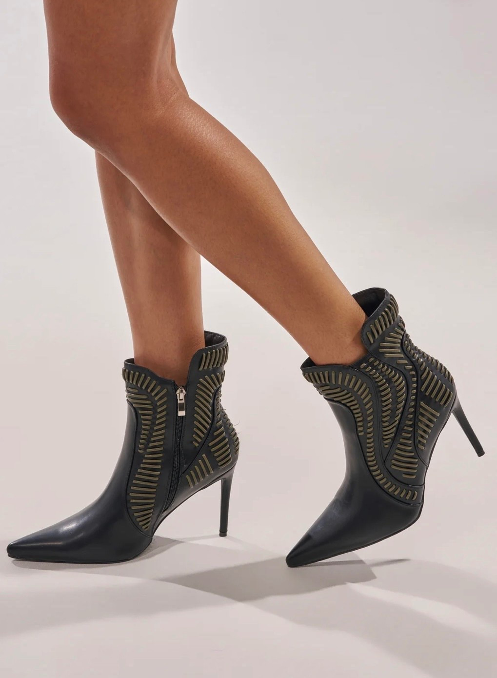 Black pointed-toe ankle boots with metallic cutout detailing and a sleek stiletto heel. Chic, modern, and made to elevate any outfit. 

#LTKootd #LTKNYFW #LTKgrwm