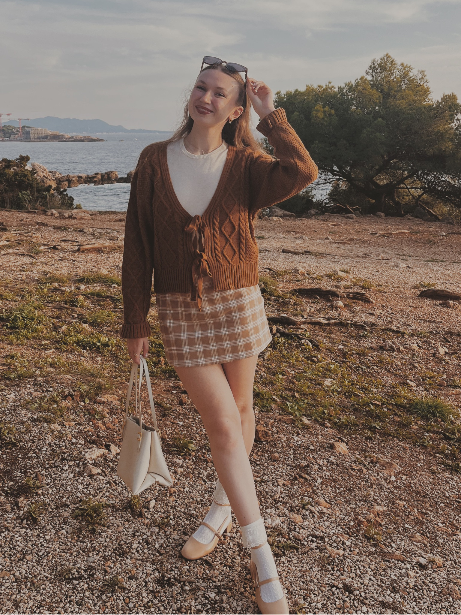 White knit T-shirt
Brown cable knit cardigan with lace closure
Brown checkered skirt
Beige Mary Jane’s

Light academia 
Light academia outfit 
Light academia style 
Light academia aesthetic 
Neutral outfit 
Autumn outfit 
Autumn fashion 
Autumn fashion inspo

#LTKOver40 #LTKSeasonal #LTKGiftGuide