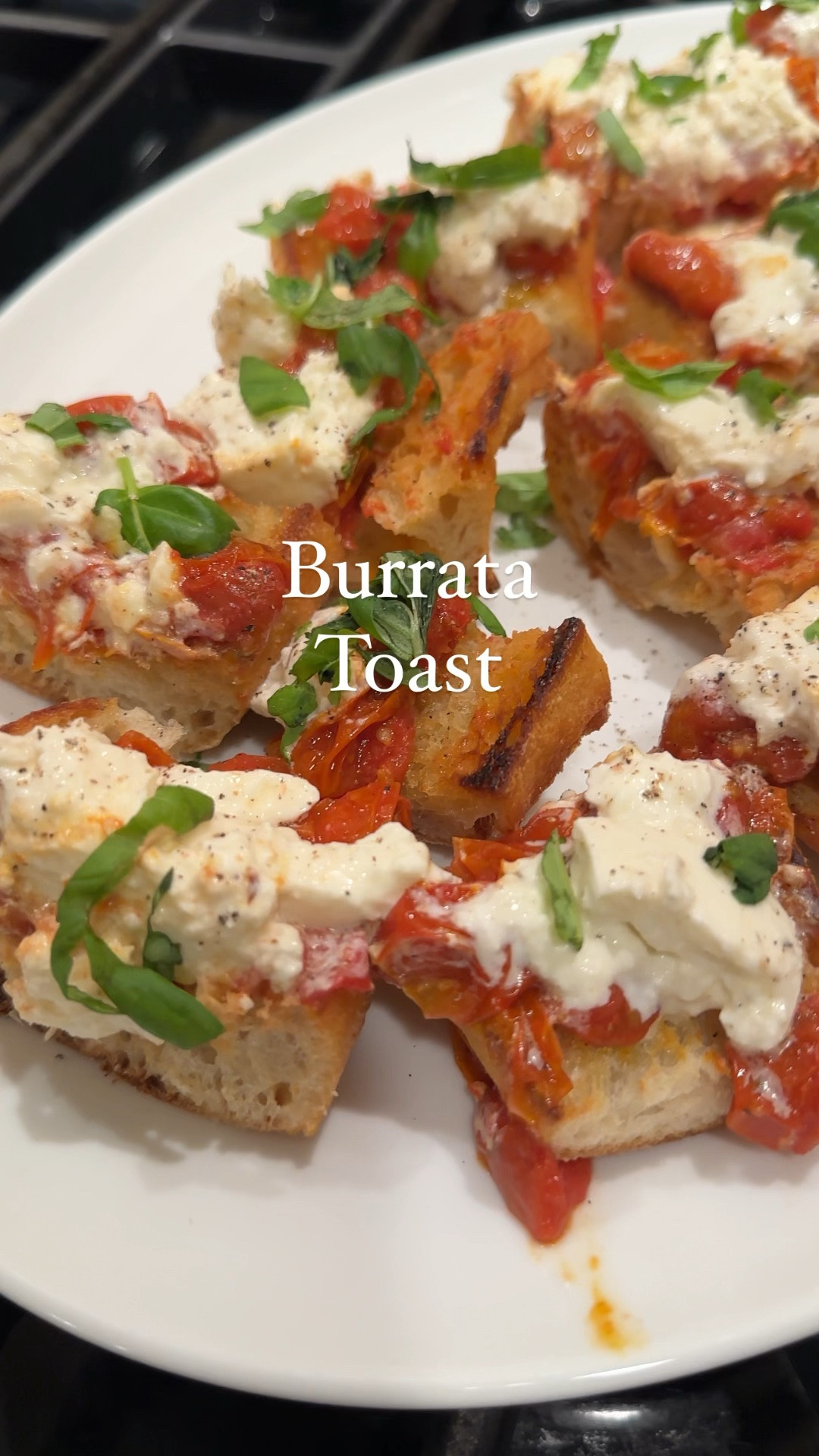 Burrata Toast

Here’s what you’ll need:
1 pint of cherry tomatoes
2 cloves of grated garlic
3 tbs olive oil
Salt and pepper and Italian seasonings
Loaf Italian bread, cut lengthwise
Olive oil
Fresh burrata
Salt and pepper
Fresh basil, chopped

Here’s how you make it:
1. Preheat the oven to 375°.
2. Add the wash tomatoes to baking dish.
3. Add the garlic, salt and pepper and toss with olive oil.
4. Bake until all tomatoes have burst and reduced down, stirring every 20 mins or so. It will take about 1 hour. Let it cool.
4. Slice bread lengthwise.
5. Heat pan with olive oil, toast in pan until golden brown.
6. Spread tomato mixture onto the bread.
7. Break apart the fresh burrata and dollop onto the bread.
8. Top with freshly chopped basil, salt, and pepper.

