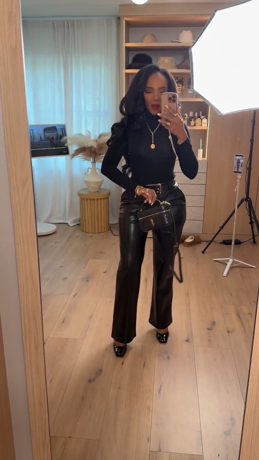 Scroll to shop 🖤  

All-black everything with a little edge. A fitted long sleeve tucked into high-waisted leather trousers for that powerful, night-out energy. Add gold accessories and a structured mini bag to elevate the entire look.  

Follow me on Instagram and YouTube @kirasfashionfinds

