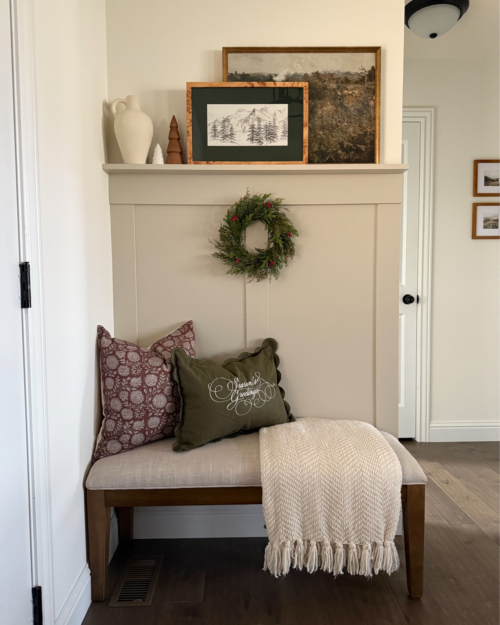 Holiday entryway views 🎄 Cozy pillows, a pop of green, and the cutest little wreath—just enough to make this small space feel festive and inviting. Loving how these simple touches bring all the merry, seasonal vibes right through the front door.

#LTKHoliday #LTKHome